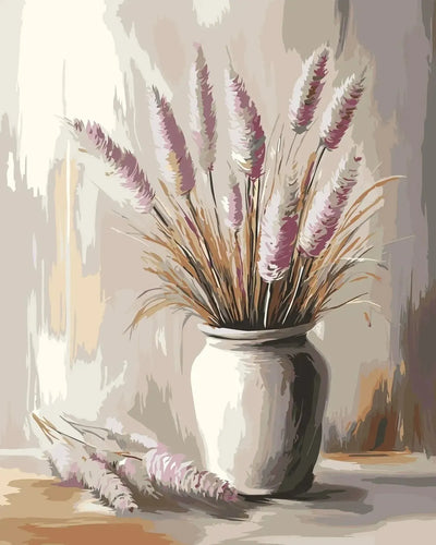 A vase of pink and beige dried flowers stands on a wooden table in warm-toned light.
