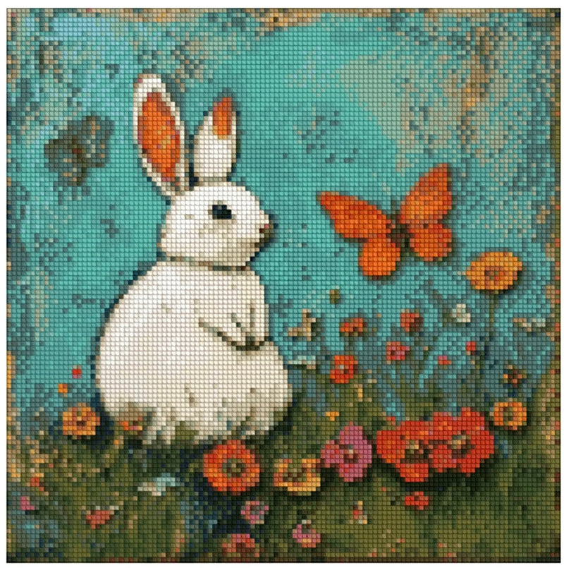 Diamond painting pattern image – a sitting white rabbit with orange ears in the middle of a meadow, with a turquoise-blue wash background and red and orange flowers in the foreground.