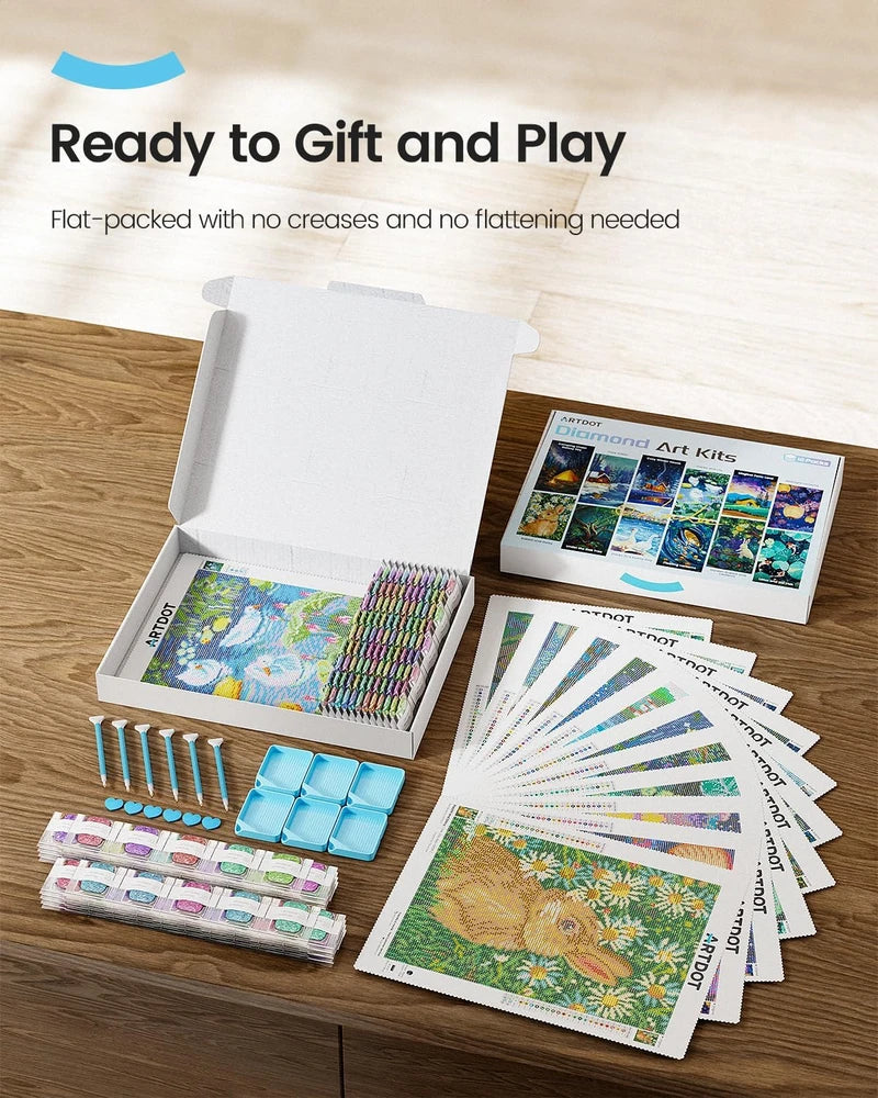 Contents of the diamond painting set in an open box – 12 canvases, diamond bags, and accessories.
