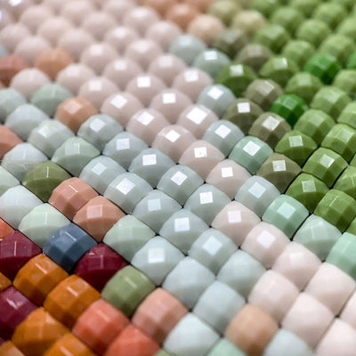 diamond painting in close-up, the image features different colored square diamonds arranged in a diamond painting.
