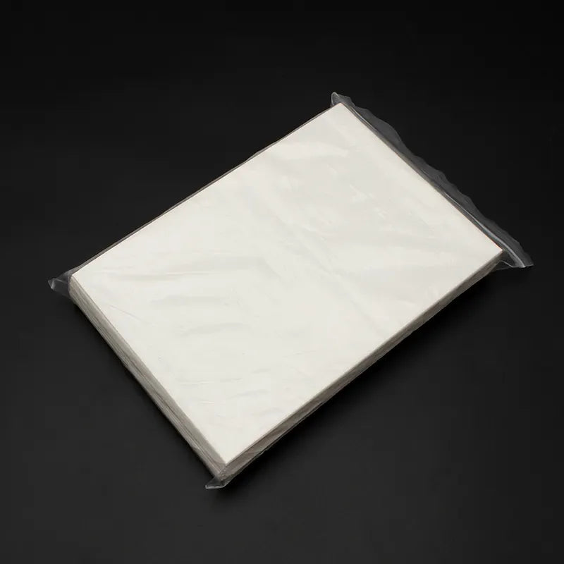 Image of the protective sheet from the package against a dark background.