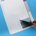 Thumbnail for In the image, a hand lifts the corner of the protective sheet from the diamond painting.
