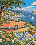 Miniatyrbild: Diamond painting-motiv med en orange veteranbil vid en picknickfilt med havet i bakgrunden