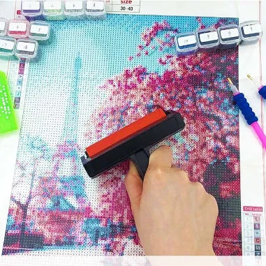 Rolling a diamond painting flat with a roller