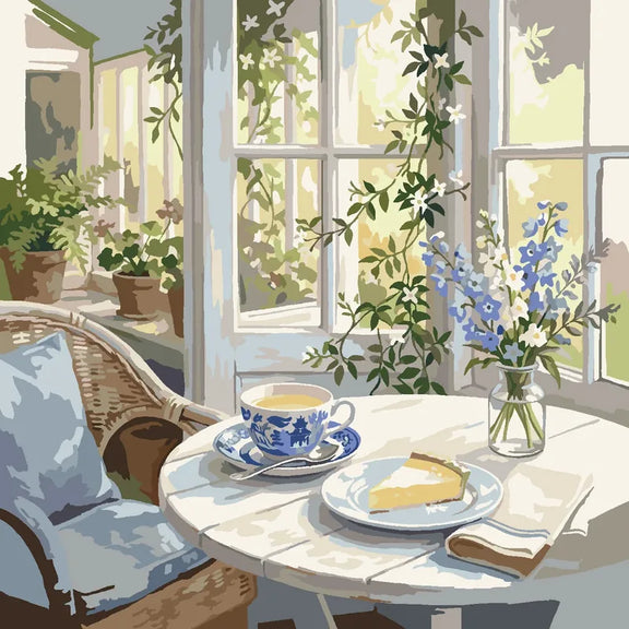 Blue-and-white teacup and slice of cake on a sunlit table beside flowers paint by numbers