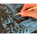 Thumbnail for Person scratching a scratch art image with a wooden stylus