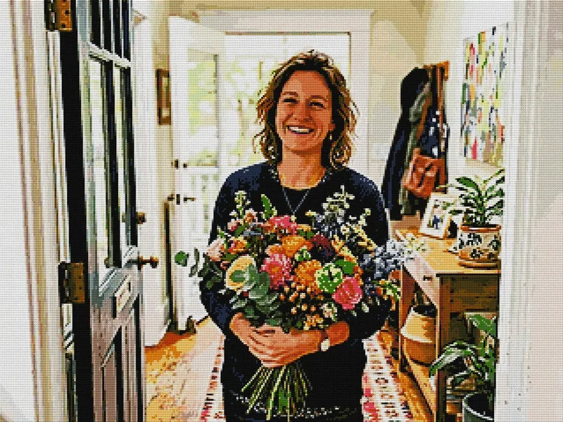 Finished custom diamond painting of a woman displayed at home